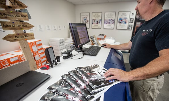 man printing brochures