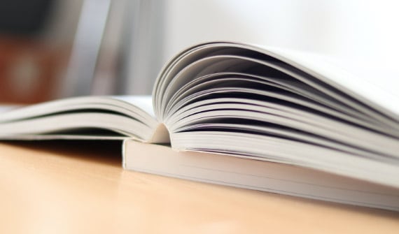perfect bound book sitting open on desk